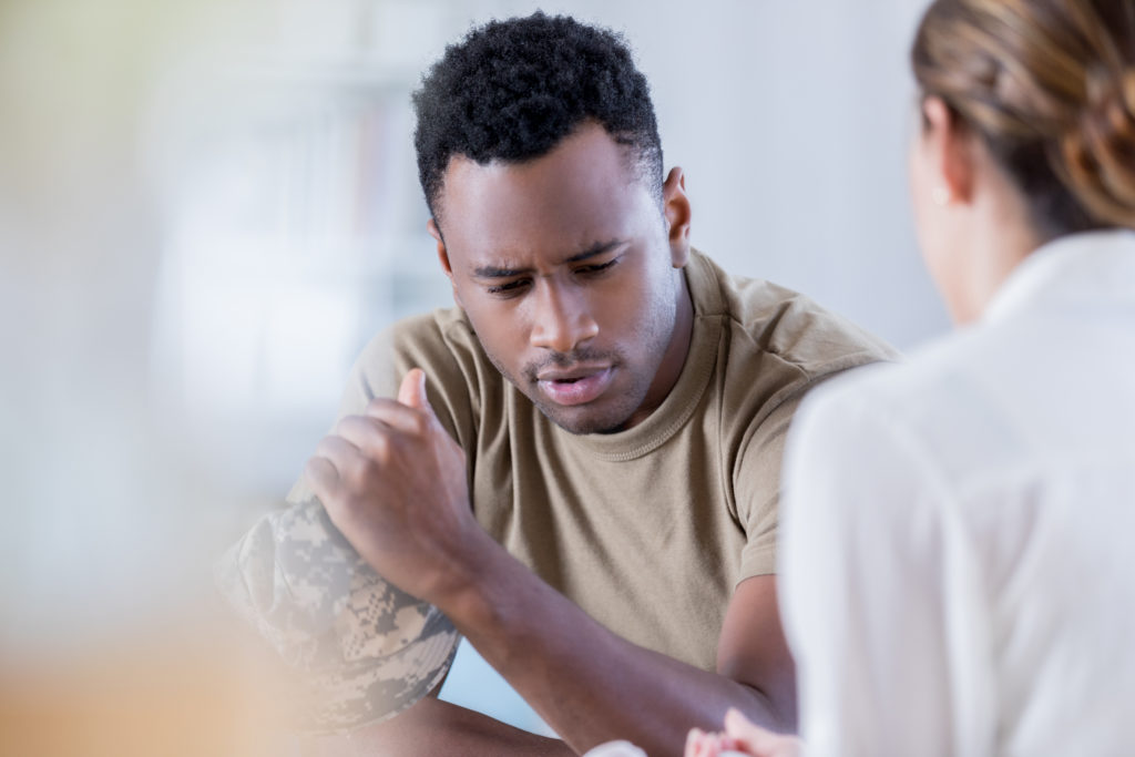 Man in military clothing receives counseling 